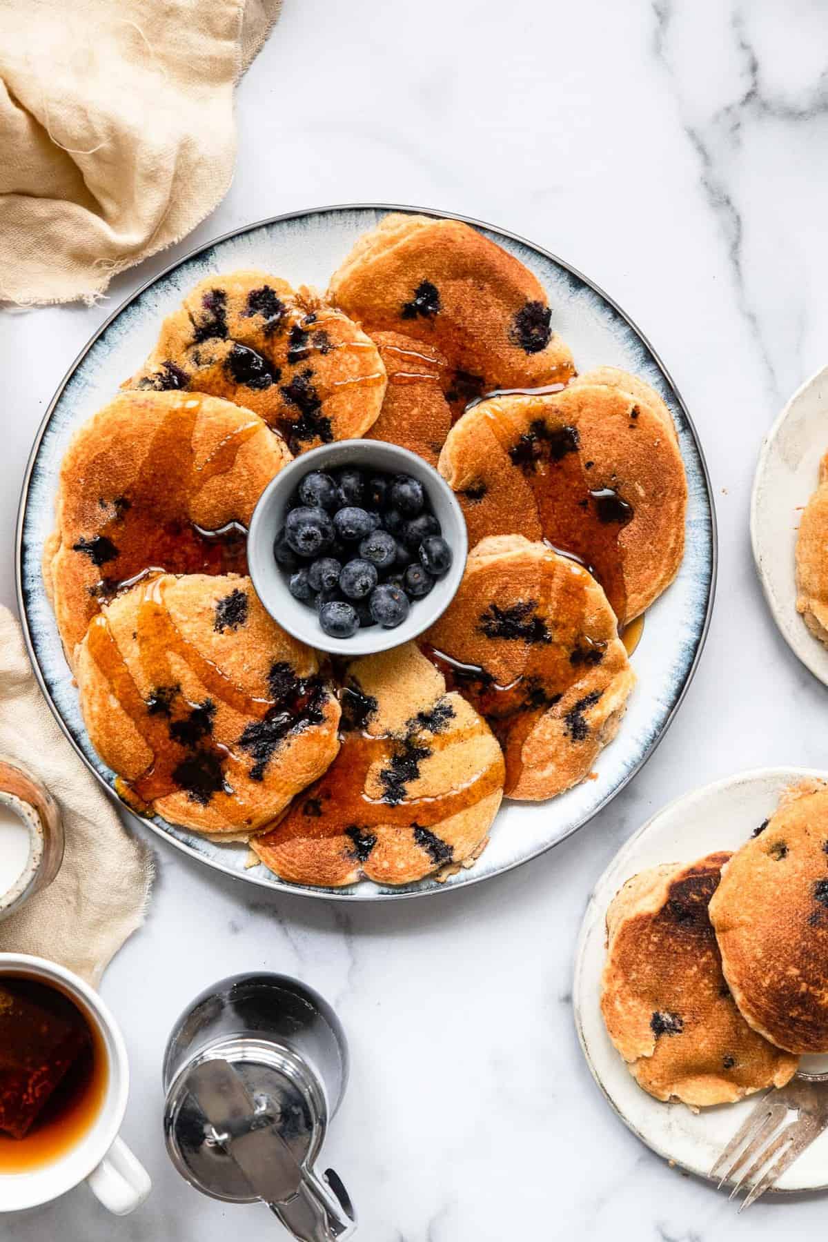Healthy Blueberry Kefir Pancakes - These blueberry pancakes are SO fluffy and delicious you will never know they are whole grain, healthy and egg free! Great for a filling breakfast! | #Foodfaithfitness | #healthy #pancakes #wholewheat #eggfree Blueberry Kefir Pancakes