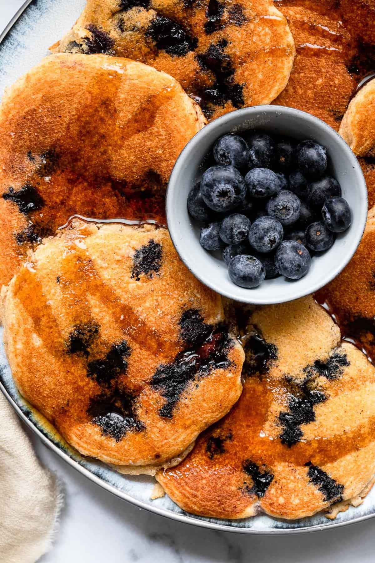 Healthy Blueberry Kefir Pancakes - These blueberry pancakes are SO fluffy and delicious you will never know they are whole grain, healthy and egg free! Great for a filling breakfast! | #Foodfaithfitness | #healthy #pancakes #wholewheat #eggfree Blueberry Kefir Pancakes
