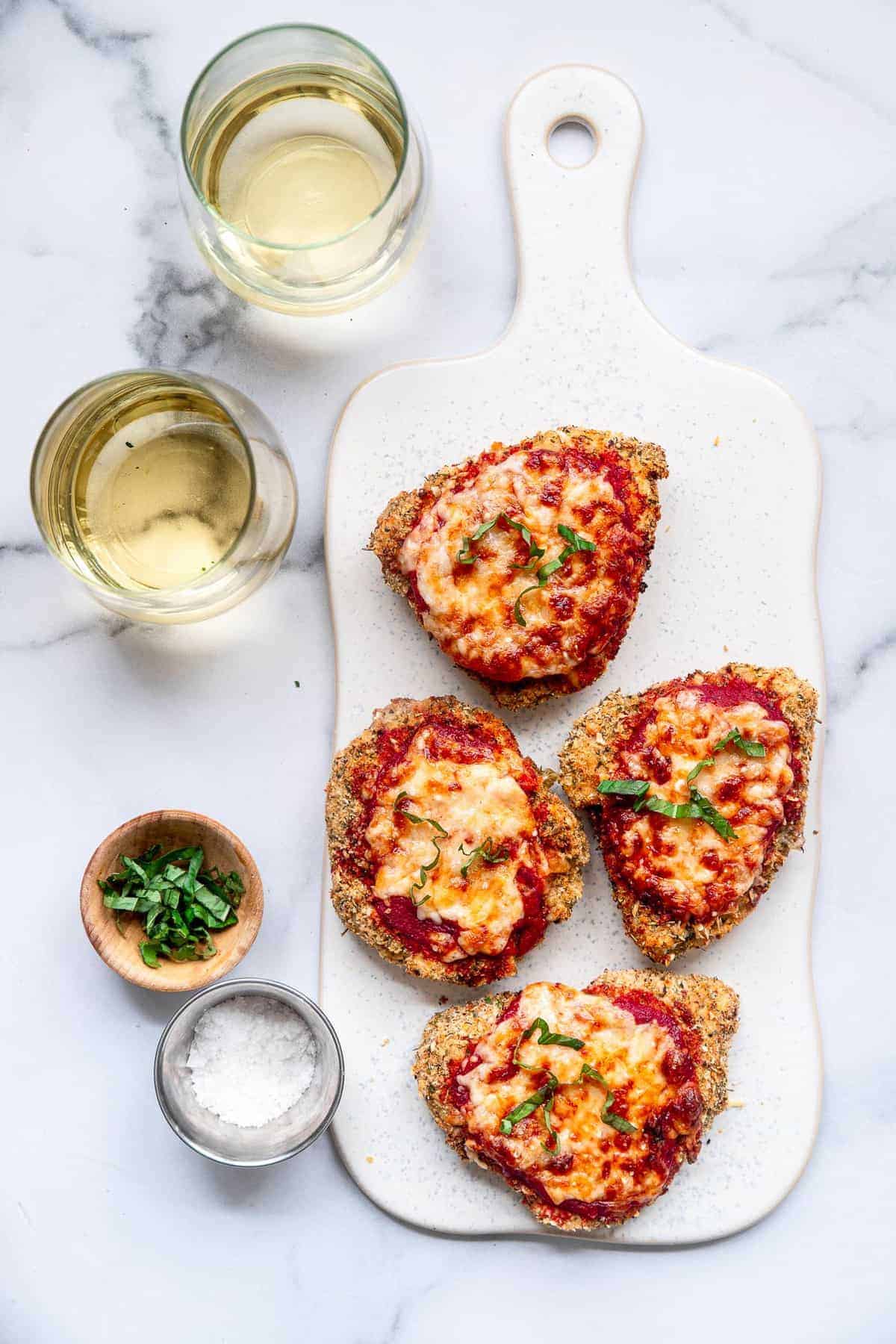 Air Fryer Chicken Parmesan on a cutting board with basil