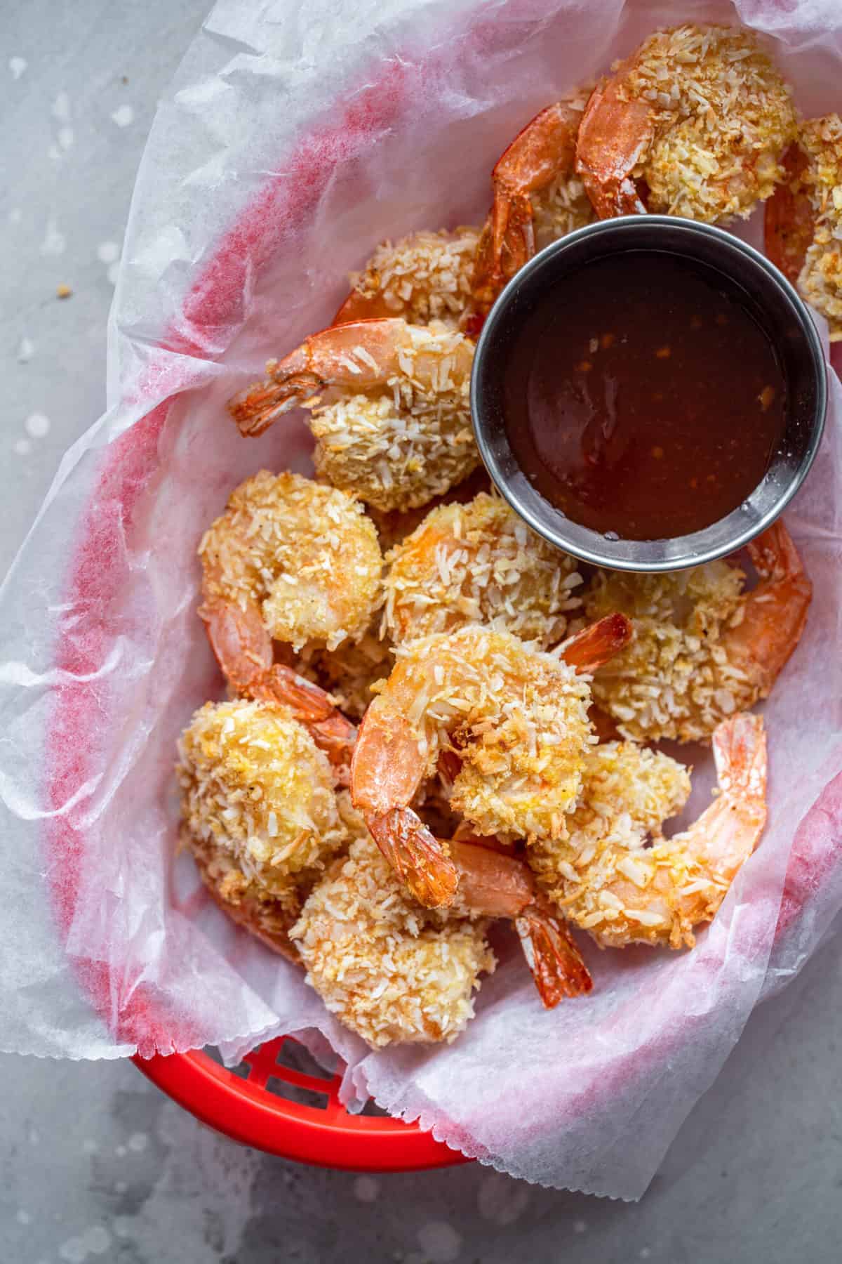 Air Fryer Coconut Shrimp - This easy Air Fryer Coconut Shrimp is just as crispy as you expect, but without the deep frying! A healthy side or dinner with a gluten free option! | #Foodfaithfitness | #glutenfree #airfryer #healthy Coconut shrimp air fryer in a basket with sauce