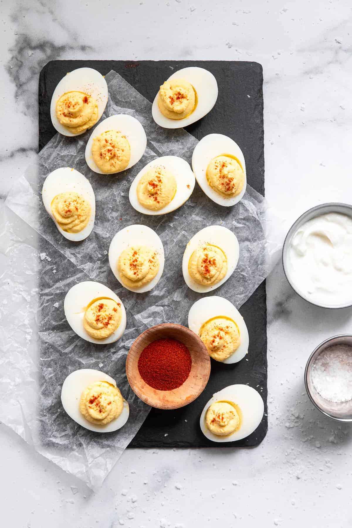 Greek Yogurt Healthy Deviled Eggs - These Healthy Deviled Eggs with Greek Yogurt are only 4 ingredients, low carb, keto friendly and packed with protein! An easy, crowd-pleasing recipe! You will never know they have no mayo! | #Foodfaithfitness | #glutenfree #keto #lowcarb #Greekyogurt #healthy Healthy deviled eggs with Greek yogurt on a plate with toppings