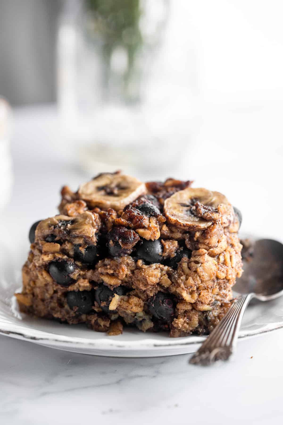 Blueberry Banana Baked Oatmeal on a small plate with a spoon
