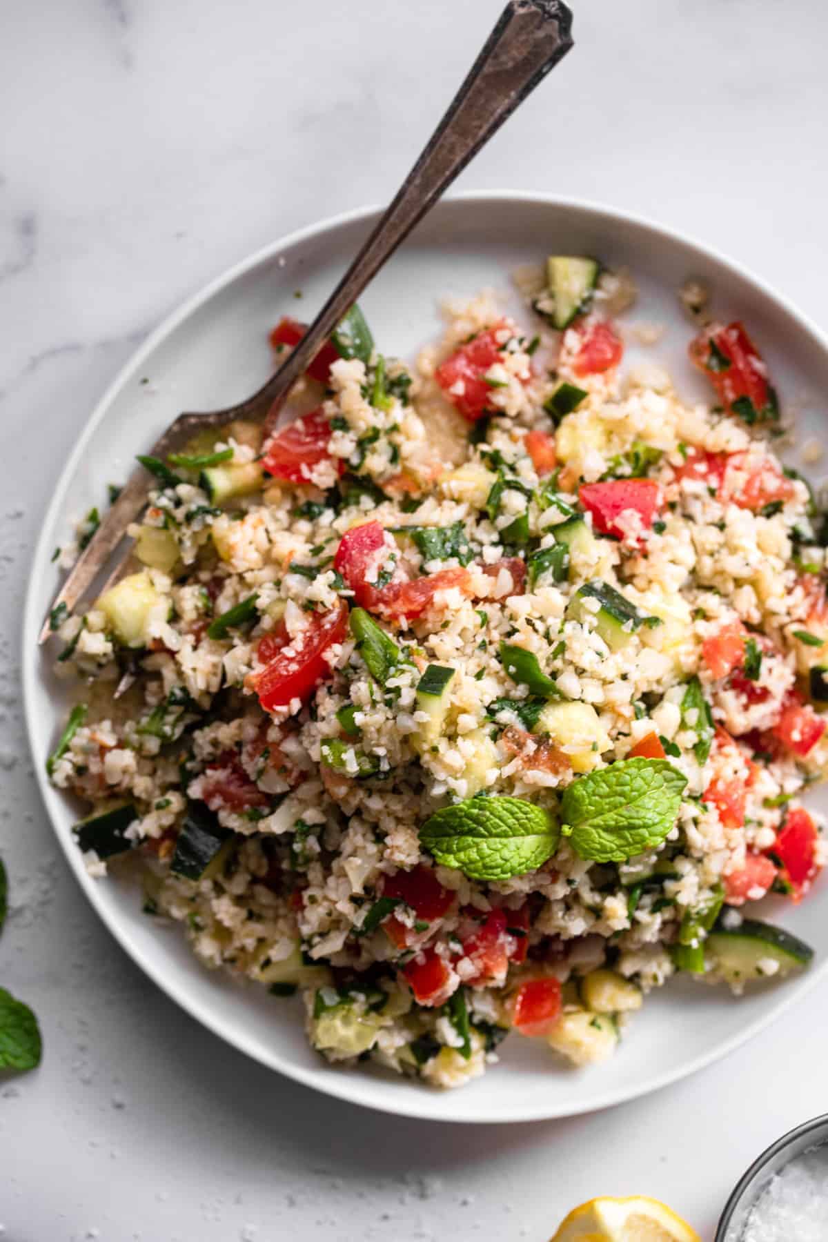 Tabbouleh Cauliflower in a serving plate with a spoon