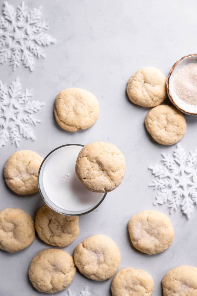 Eggless Sugar Cookies on a table with a glass of milk