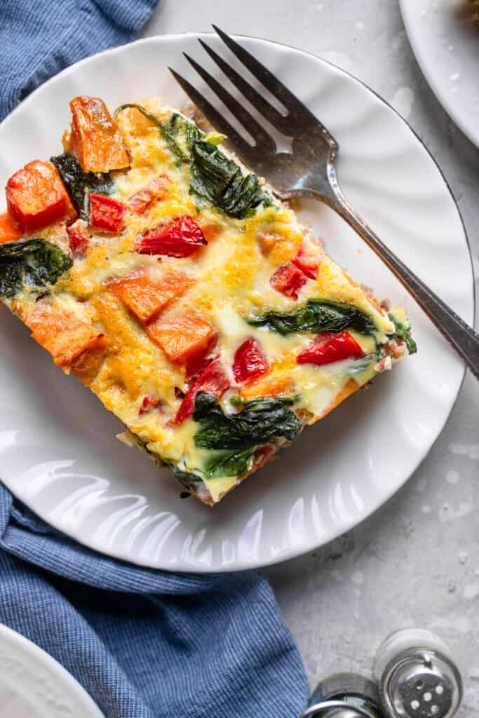 one slice of Whole30 Breakfast Casserole on a plate with a fork