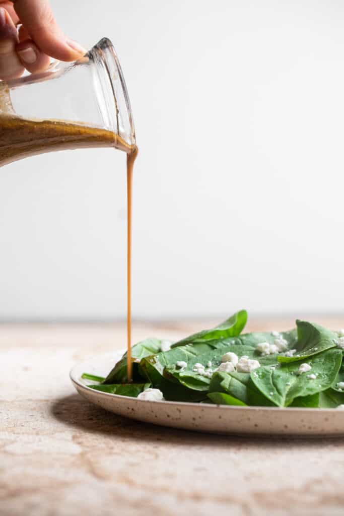 Whole30 Balsamic Vinaigrette being poured on a salad