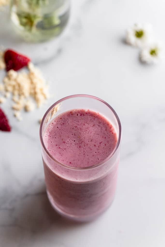 Strawberry Protein Shake in a skinny glass on a table