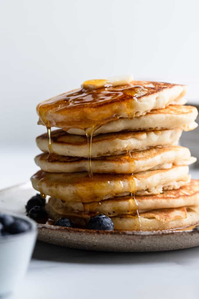 Dairy Free Pancakes on a plate with blueberries and syrup