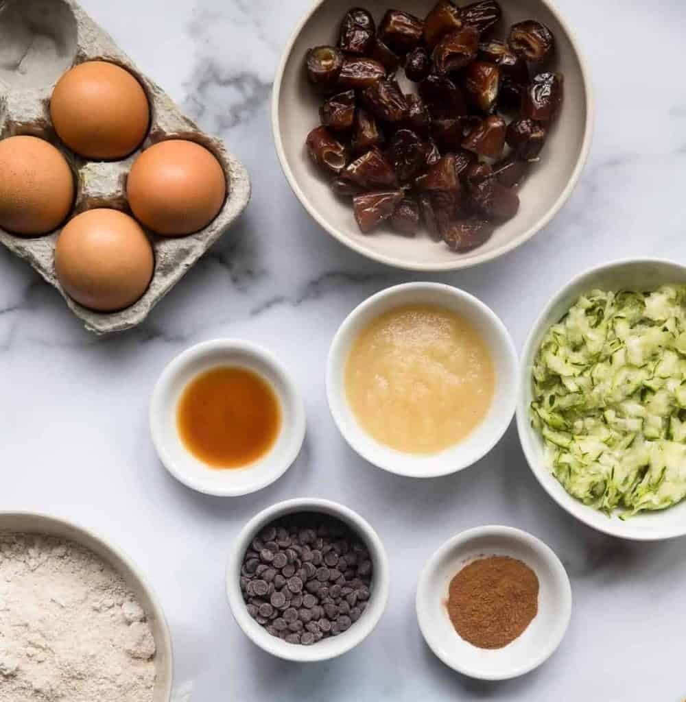 Healthy Gluten Free Zucchini Muffins - These dairy free Zucchini Muffins are fluffy and gluten, dairy, oil and sugar free! Sweetened with dates, studded with chocolate chips and only 170 calories! Great for kids and adults! | #Foodfaithfitness | #Glutenfree #Dairyfree #Healthy #Zucchini #sugarfree