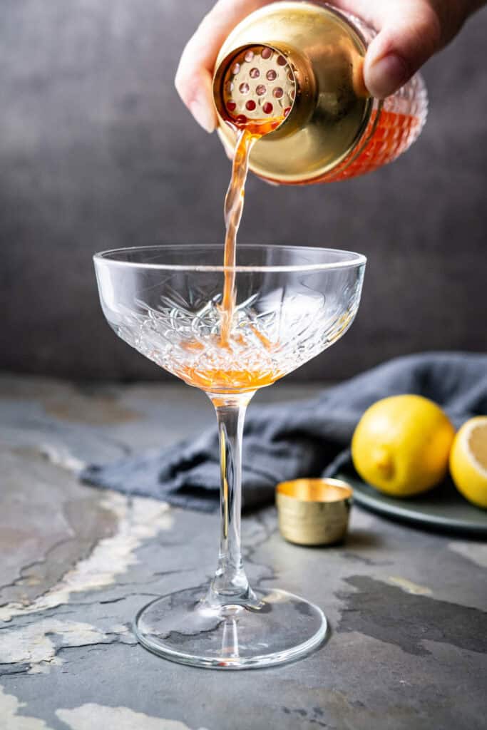 Pouring a cocktail on a paper plane