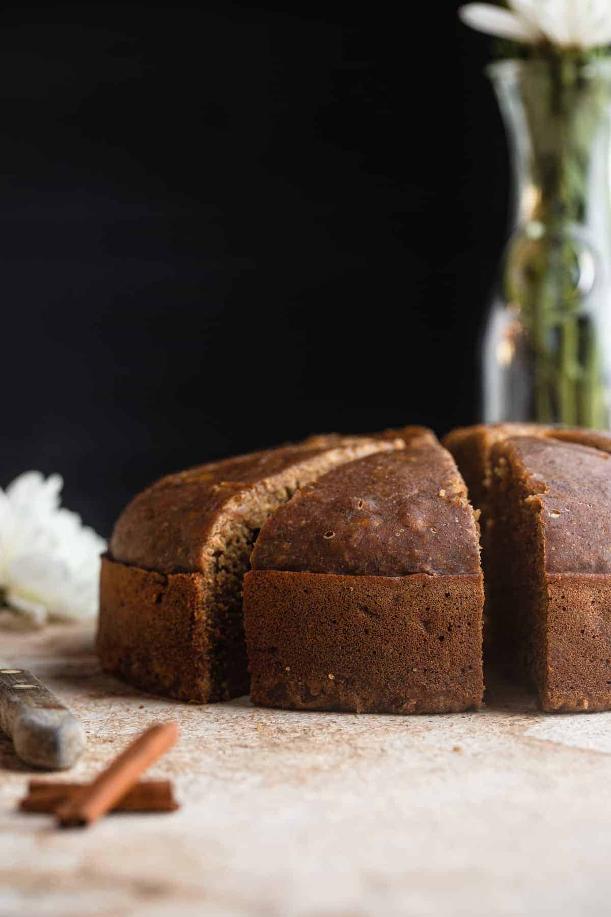 An instant pot of banana bread on a table with flowers