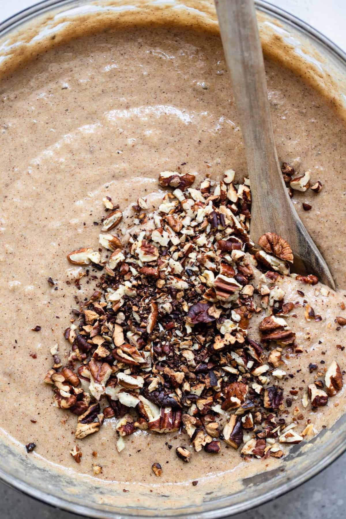 The batter of sugar free banana bread with chopped pecans