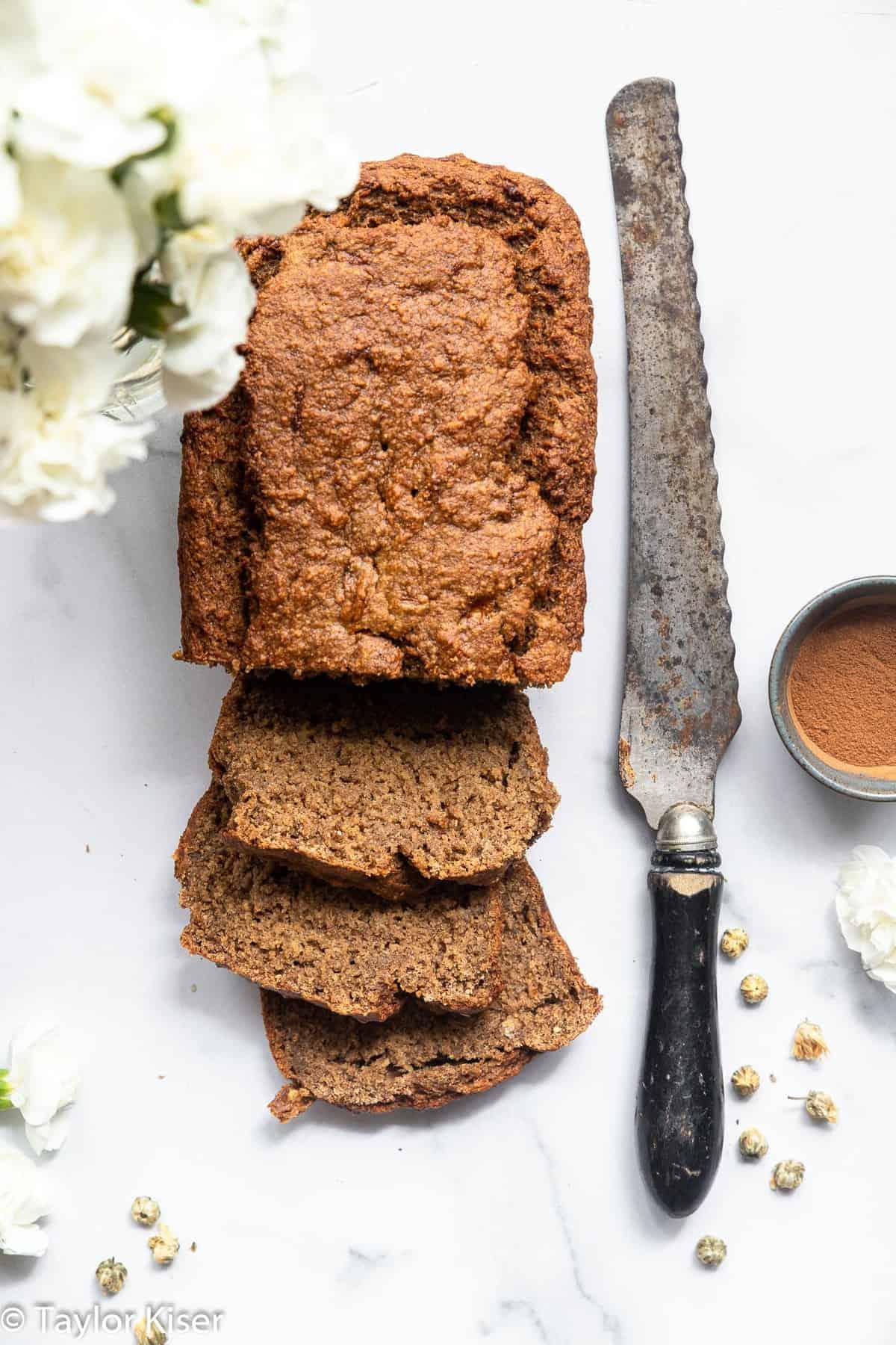 Vegan Gluten Free Banana Bread - This Vegan Gluten Free Banana Bread is so soft, chewy and perfectly sweet you would never know it's gluten, dairy and egg free and healthy! | #Foodfaithfitness | #Glutenfree #vegan #dairyfree #eggfree #healthy overhead of vegan gluten free banana bread with a knife beside it