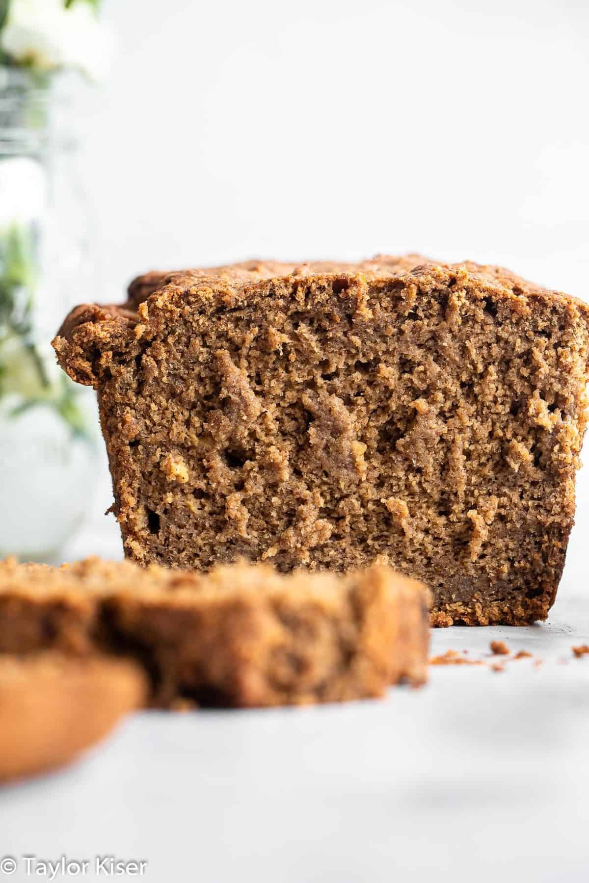 Vegan Gluten Free Banana Bread - This Vegan Gluten Free Banana Bread is so soft, chewy and perfectly sweet you would never know it's gluten, dairy and egg free and healthy! | #Foodfaithfitness | #Glutenfree #vegan #dairyfree #eggfree #healthy close up of healthy vegan banana bread on a counter