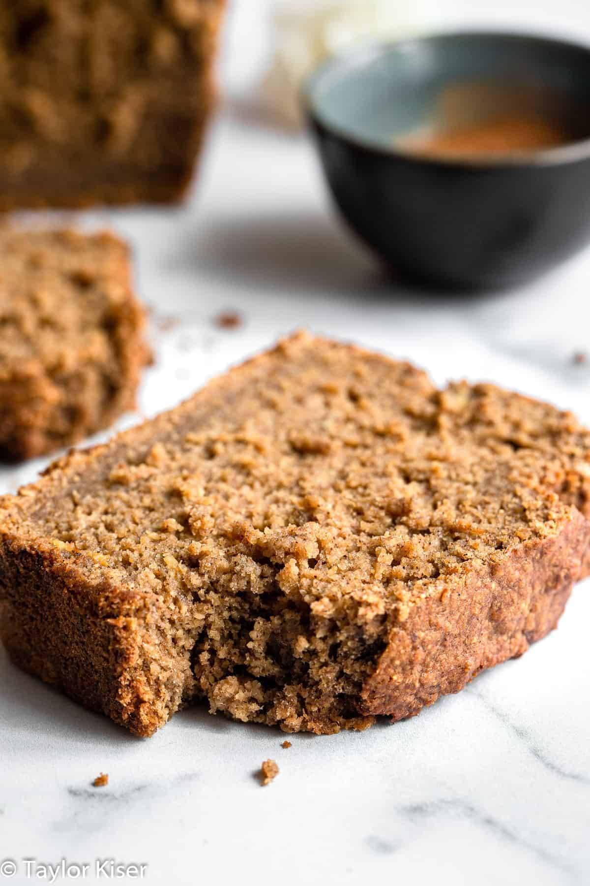 Vegan Gluten Free Banana Bread - This Vegan Gluten Free Banana Bread is so soft, chewy and perfectly sweet you would never know it's gluten, dairy and egg free and healthy! | #Foodfaithfitness | #Glutenfree #vegan #dairyfree #eggfree #healthy vegan gluten free banana bread with a bite out of a slice