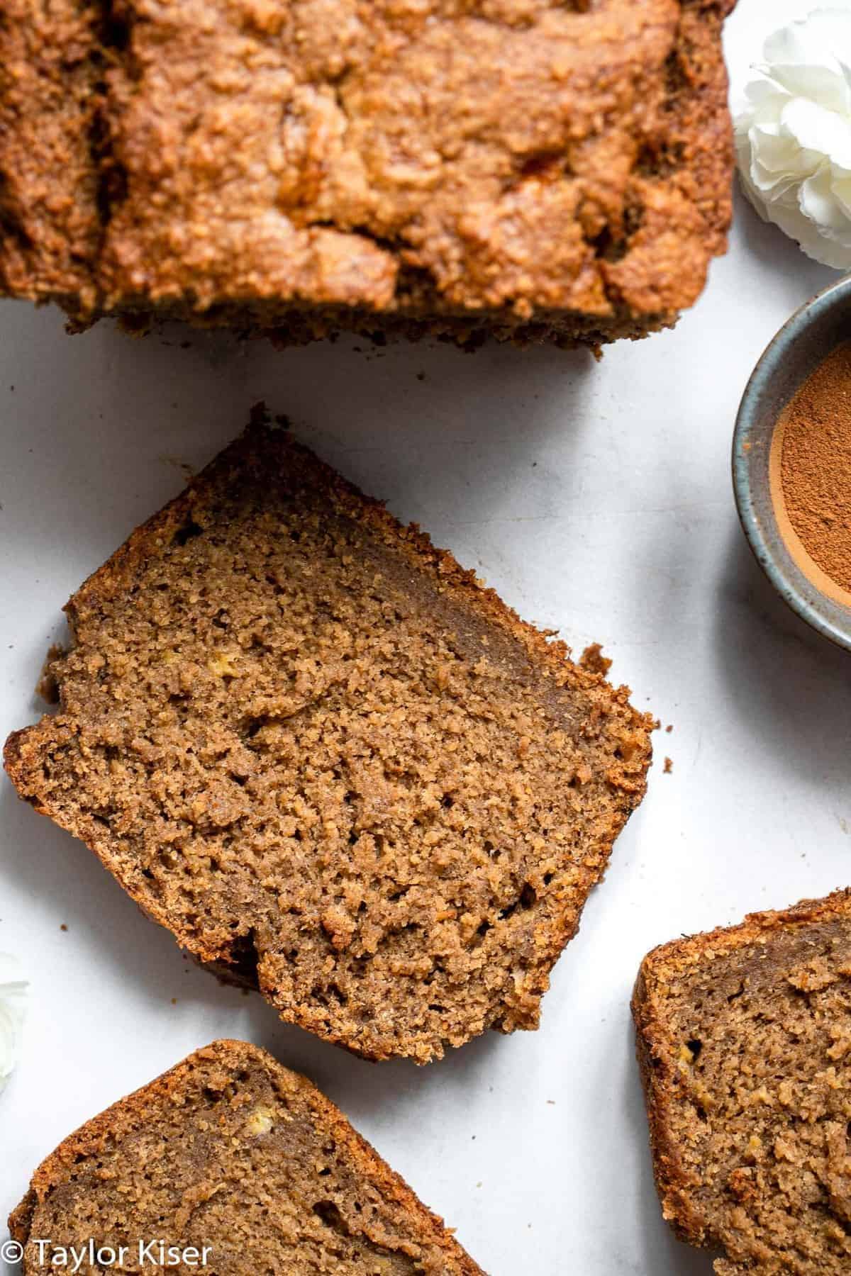 Vegan Gluten Free Banana Bread - This Vegan Gluten Free Banana Bread is so soft, chewy and perfectly sweet you would never know it's gluten, dairy and egg free and healthy! | #Foodfaithfitness | #Glutenfree #vegan #dairyfree #eggfree #healthy gluten free dairy free banana bread sliced on a table