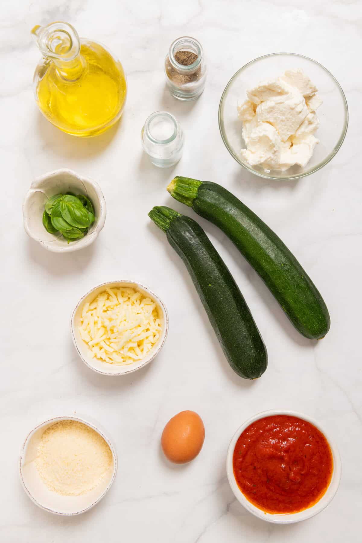 Ingredients for Zucchini Lasagna Rolls: zucchini, ricotta, mozzarella, Parmesan, egg, basil, marinara, oil.