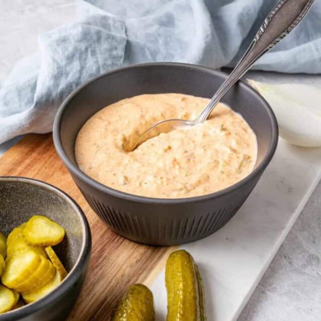 Creamy homemade onion dip served with pickles and cucumbers on a wooden board, perfect for healthy snacking and meal prep.