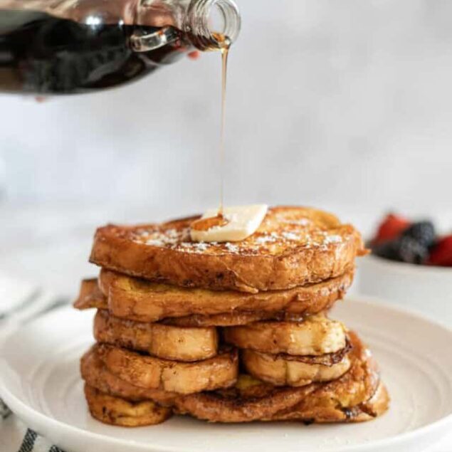 Sweet French toast topped with syrup and butter on a white plate, highlighting delicious breakfast ideas and healthy eating options.