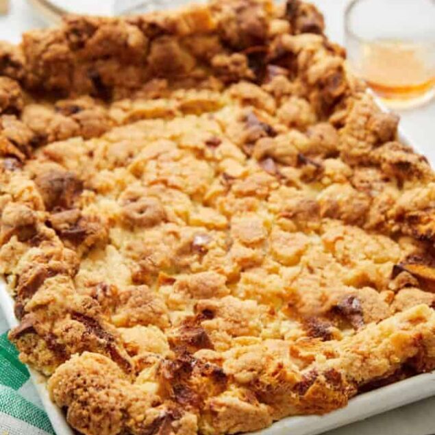 Butter pecan crumble dessert with crumbly topping in a white baking dish.