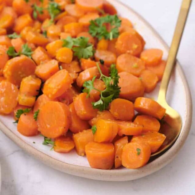 Roasted sweet potatoes with herbs on a white plate, healthy vegan side dish for meal prep and balanced diet.