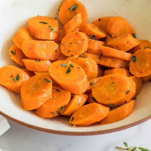 Roasted sweet potatoes with herbs and black pepper in a white bowl, healthy vegetable side dish, nutritious dinner idea, Food Faith Fitness.