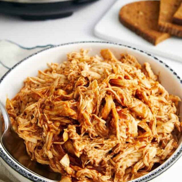 Tender shredded chicken in a flavorful sauce, perfect for healthy meals or meal prep; easy to make in a slow cooker or Instant Pot for nutritious, high-protein recipes.