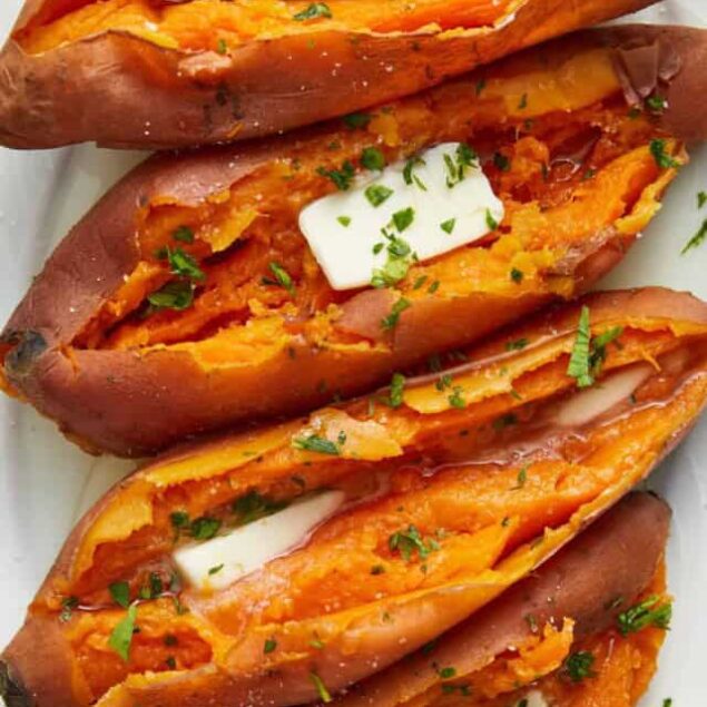 Sweet Potato Nachos with melted cheese, sour cream, and chopped herbs, served as a healthy and delicious vegetarian snack or meal option. Perfect for meal prep or sharing with friends.
