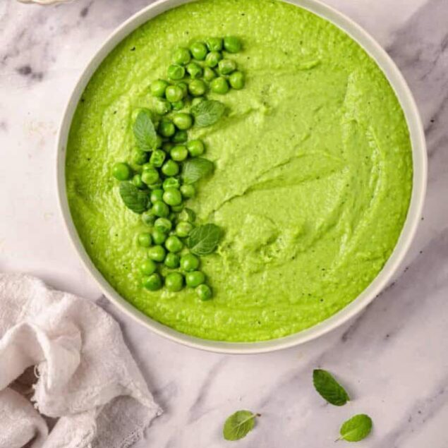 Creamy green pea hummus with fresh peas and mint garnishes for healthy snacks. Perfect for vegan, vegetarian, and gluten-free diets, this easy recipe offers a nutritious, flavorful appetizer or dip option.