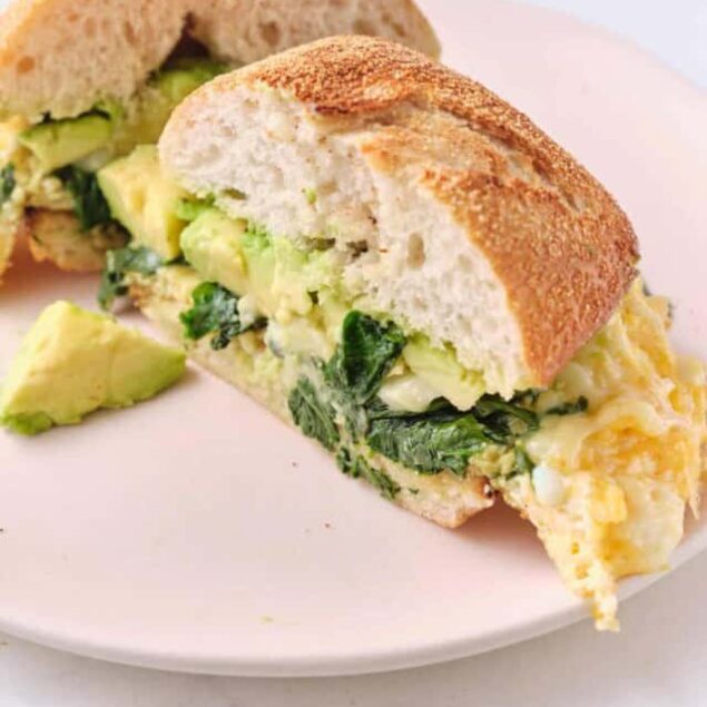 Creamy breakfast burrito with scrambled eggs, fresh spinach, and avocado in a toasted baguette roll, healthy breakfast ideas, high-protein meal, easy brunch recipes, Food Faith Fitness.