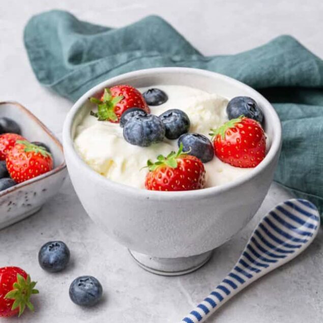 Fresh Greek yogurt with strawberries and blueberries, a healthy protein-rich breakfast or snack option. Perfect for a nutritious, balanced diet and weight management.