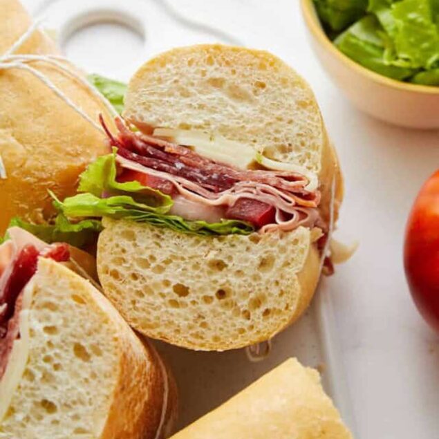 Whole grain sandwich bread with turkey, ham, cheese, lettuce, and tomato, perfect for a healthy and delicious meal. Fresh ingredients and balanced nutrition for a wholesome diet.
