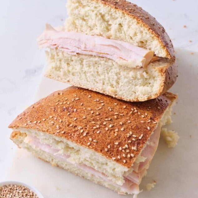 Fluffy turkey sandwich on sesame seed bun with sliced turkey and light mayo, close-up, bread, lunch, healthy food, protein-rich meals, Food Faith Fitness.