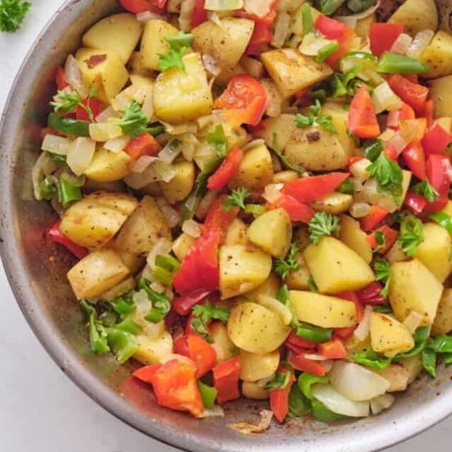 Roasted potato vegetable hash with red bell peppers, onions, and fresh herbs, perfect for a healthy breakfast or side dish. Nutrient-rich, easy to make, and packed with flavor.