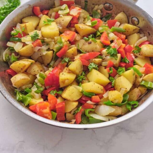 Creamy roasted potato and vegetable hash for healthy breakfast and meal prep, packed with colorful bell peppers, onions, and fresh herbs, perfect for nutritious eating.