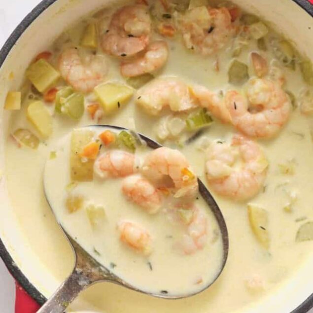 Creamy shrimp and celery soup in a red pot, featuring fresh seafood, vegetables, and a savory broth, perfect for healthy meal options and seafood recipes.