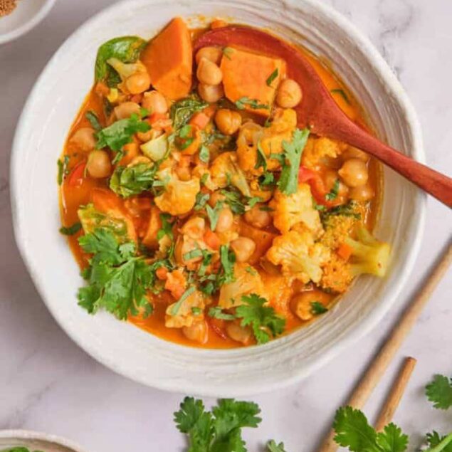 Flavorful vegetarian chickpea cauliflower curry featuring vibrant vegetables and fresh cilantro, perfect for healthy, easy-to-make plant-based meals.