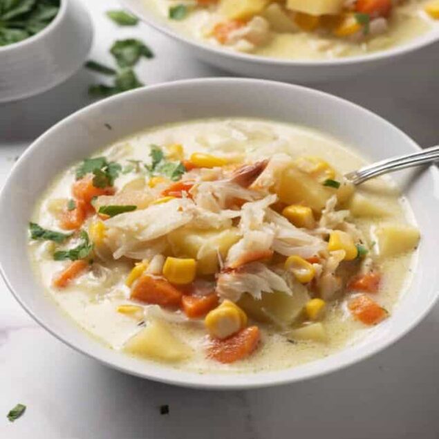 Comfort food chicken corn chowder with vegetables in a white bowl healthy homemade soup.
