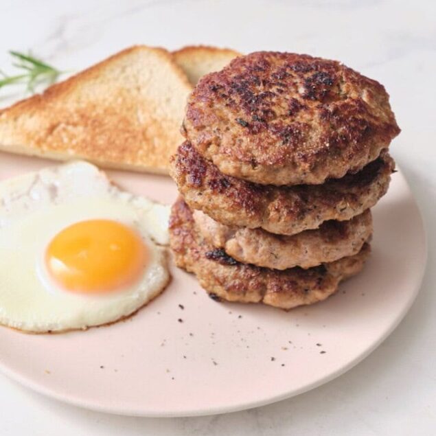 Juicy homemade beef patties with sunny side up egg, toasted bread, and herbs; healthy breakfast options from Food Faith Fitness.