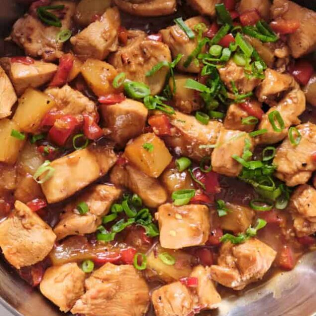 Juicy, healthy chicken stir-fry with vegetables, soy sauce, and green onions in a skillet, perfect for nutritious meals.