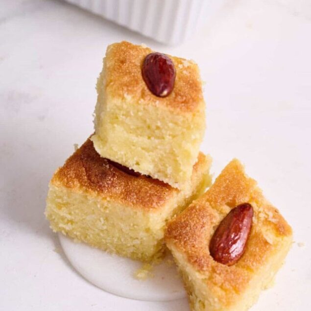 Delicious coconut squares topped with almonds, perfect for healthy snacks or dessert recipes. Easy to make with simple ingredients for a nutritious treat.