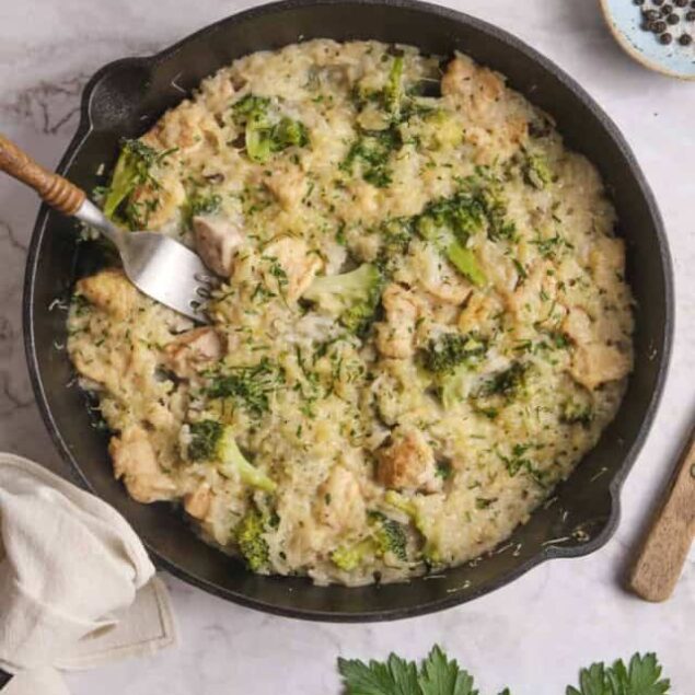 Creamy Chicken and Broccoli Cauliflower Rice Casserole with herbs and cheese, healthy comfort food recipe, easy nutritious meal idea.