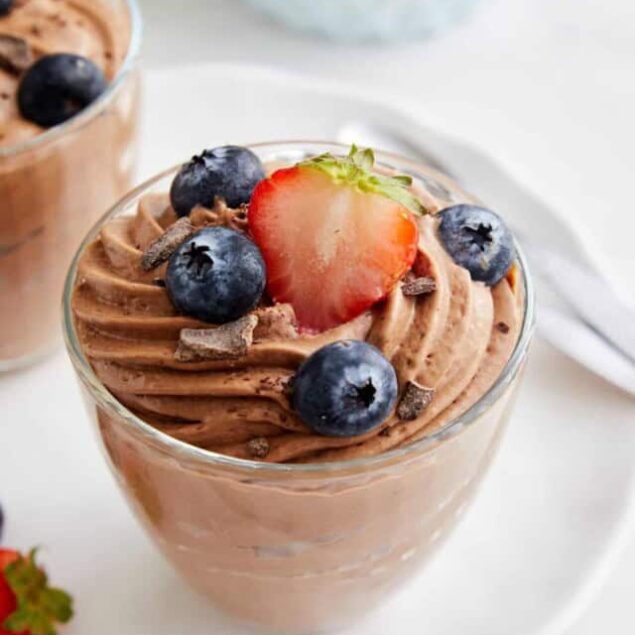 Creamy chocolate mousse topped with fresh strawberries and blueberries, perfect for healthy dessert recipes and fruit lovers.