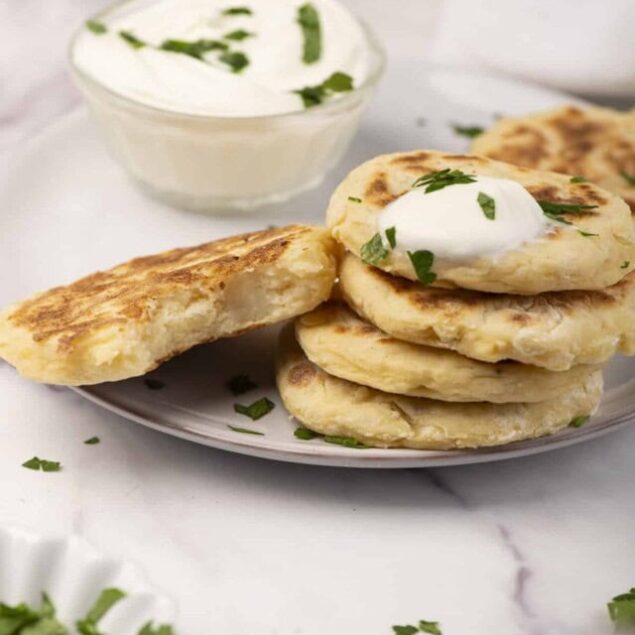 Fluffy homemade Greek yogurt flatbreads with creamy tzatziki and fresh herbs, perfect for healthy snack or meal option. Made with wholesome ingredients, low-calorie, and high-protein.