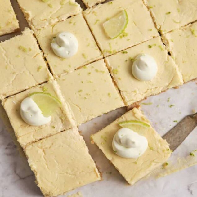 Creamy lime bars topped with whipped cream and lime wedges, perfect for a refreshing dessert. Easy to make and packed with citrus flavor, ideal for summer gatherings and healthy treat options.
