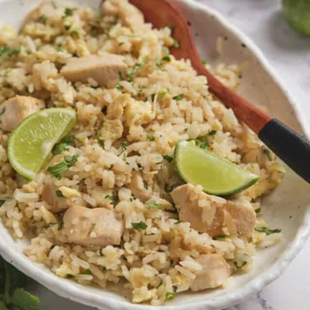 Super healthy chicken and rice skillet with lime wedges for added flavor.