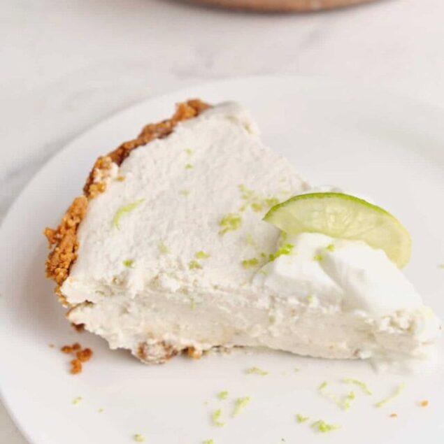 Creamy lime cheesecake with a graham cracker crust and fresh lime garnish, perfect for healthy dessert options.