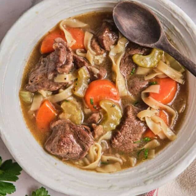 Savory beef stew with carrots, celery, and egg noodles in a rich broth, perfect for comforting home-cooked meals and healthy dinner options.