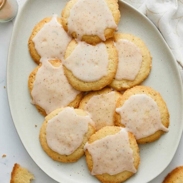 Butter cookies with vanilla glaze on white plate, baked homemade dessert, gluten-free sweet treats, Food Faith Fitness healthy baking recipes, delicious cookie recipe with simple ingredients.