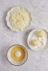 Potato balls being coated in flour, egg wash, and panko breadcrumbs.